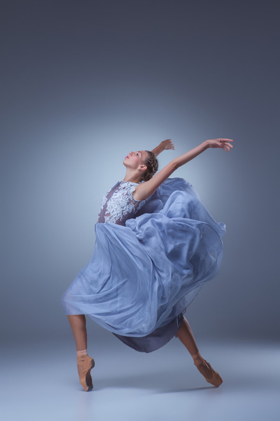 The beautiful ballerina dancing in blue long dress - 写真・画像