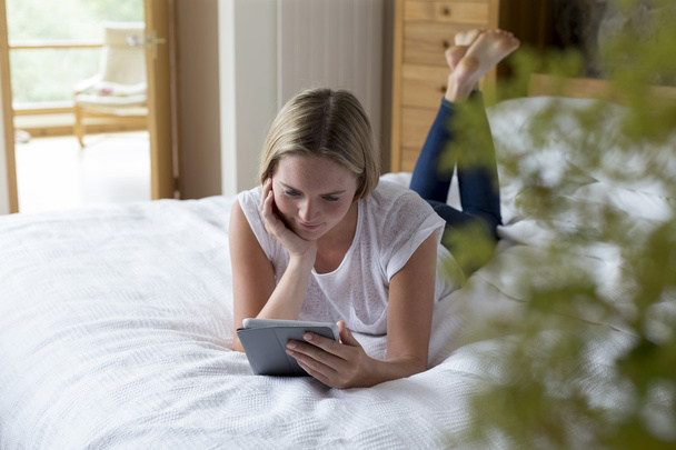 Woman using digital tablet at home - Photo, Image