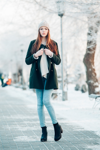 Beautiful winter portrait of young woman in the snowy scenery - Photo, Image