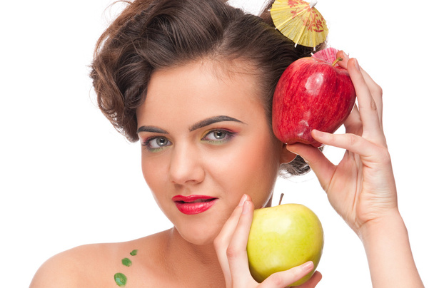 Close up portrait of young emotional woman with apple - 写真・画像