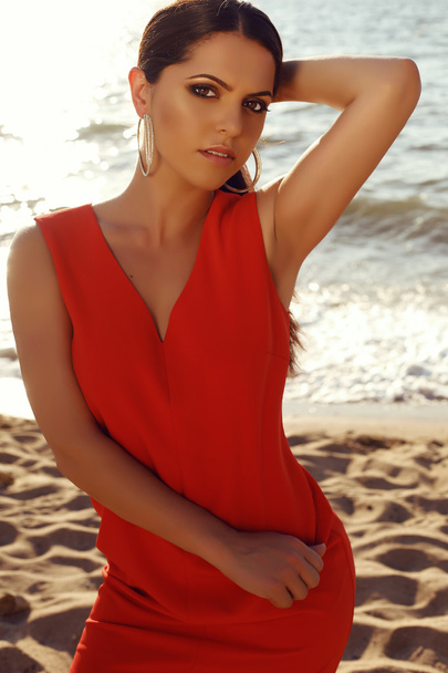 beautiful girl in elegant red dress relaxing on summer beach - Φωτογραφία, εικόνα