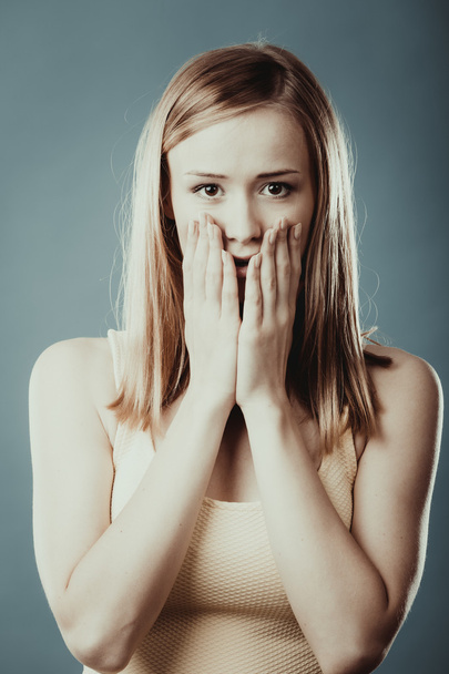 Amazed woman covering her mouth with hands - Photo, Image