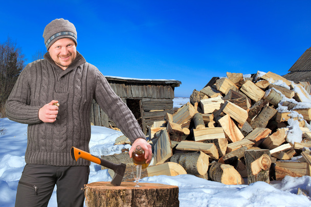 Man collecting firewood in winter outdoor - Фото, изображение