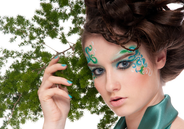 Close-up of sprite girl with faceart and plant - Fotografie, Obrázek