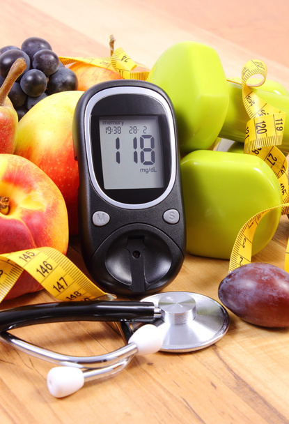Glucose meter with medical stethoscope, fruits and dumbbells for using in fitness - Fotoğraf, Görsel