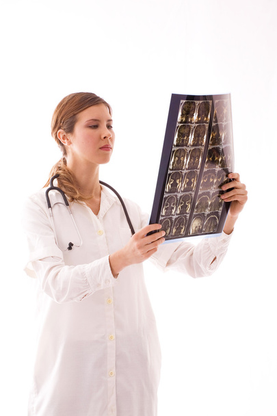 Young female doctor examines a radiogram. - Фото, зображення