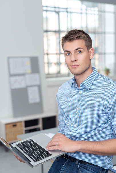 Handsome Businessman with Laptop Looking at Camera - Foto, immagini