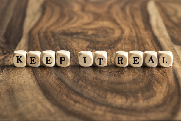 Word KEEP IT REAL on wooden cubes - Photo, Image