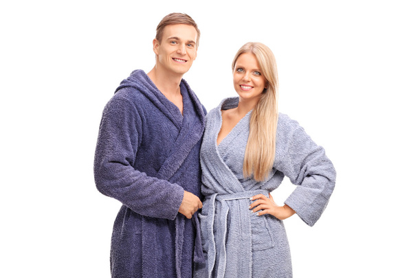 Young couple in blue bathrobes hugging - Foto, imagen