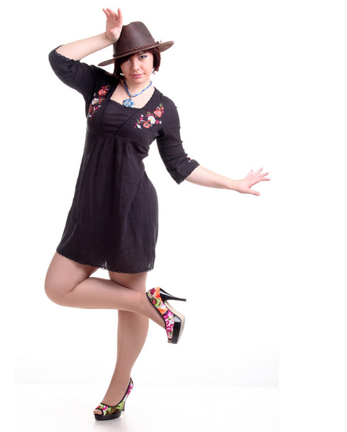brunette girl poses in black dress and hat - Фото, изображение
