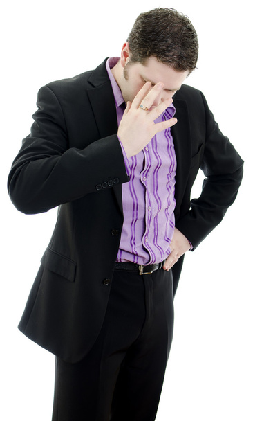 Portrait of a young business man looking depressed from work. Isolated over - Photo, Image