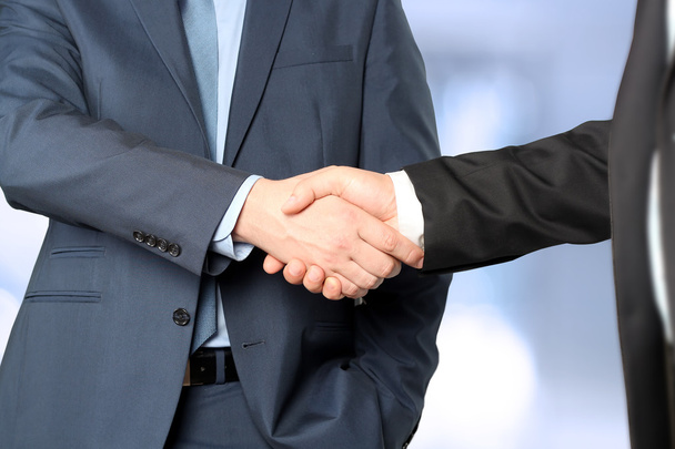 Close-up image of a firm handshake  between two colleagues in office. - Photo, Image