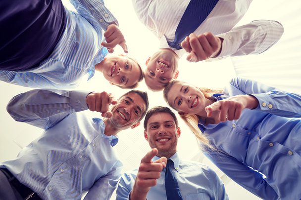 usmívající se skupina podnikatelů stojící v kruhu - Fotografie, Obrázek