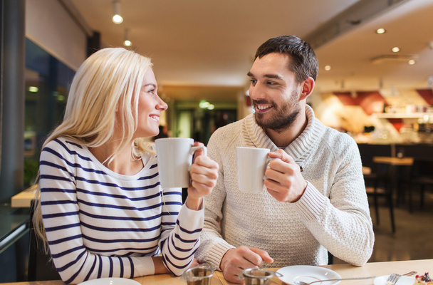 happy couple meeting and drinking tea or coffee - Фото, изображение