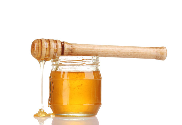 Jar of honey and wooden drizzler isolated on white - Foto, Imagem