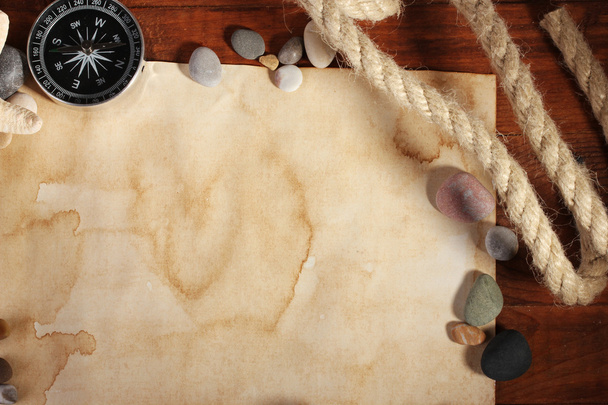 Old paper, compass and rope on a wooden table - Photo, image