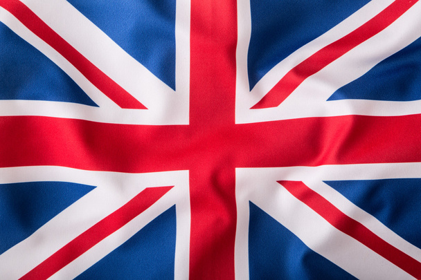 British Union Jack flag blowing in the wind. - Fotoğraf, Görsel
