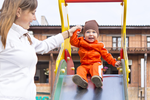Small boy with a smile on children's slide - Zdjęcie, obraz