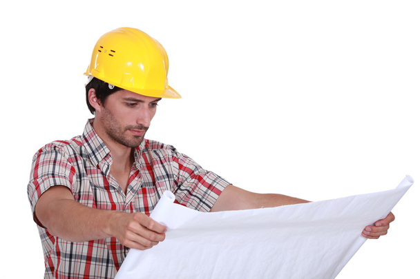 A foreman checking plans. - Фото, зображення