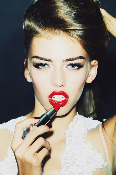 Girl putting on lipstick - Φωτογραφία, εικόνα