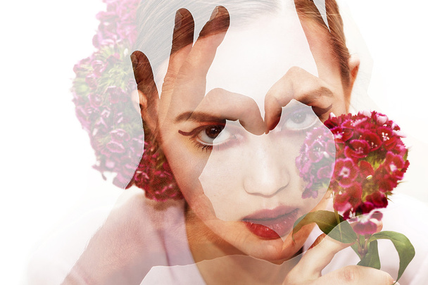 Double exposure of girl with flowers and heart gesture - Foto, Imagem