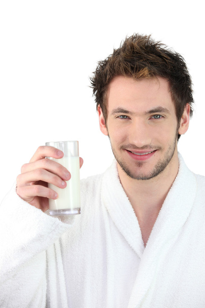 Man in dressing gown drinking glass of milk - Photo, Image