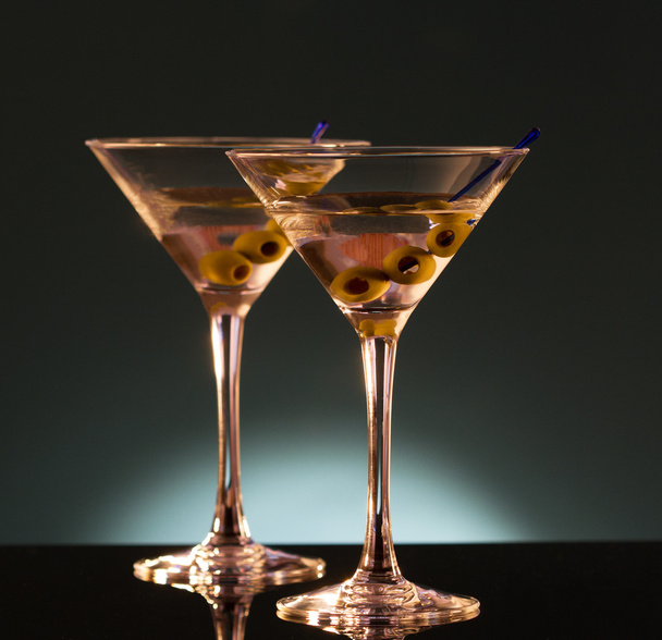 Two glasses with martini , focus on a olives - Fotó, kép