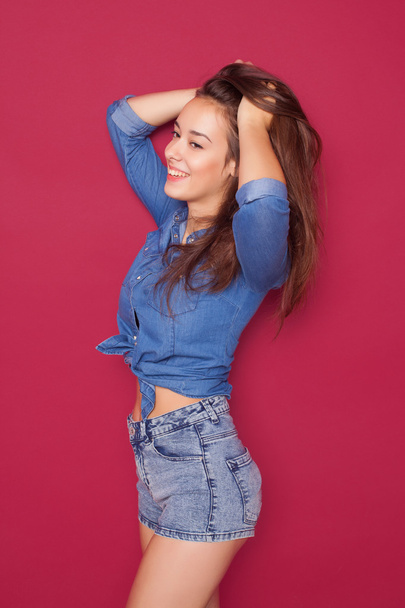 young happy beautiful girl posing grimacing in studio - Fotó, kép