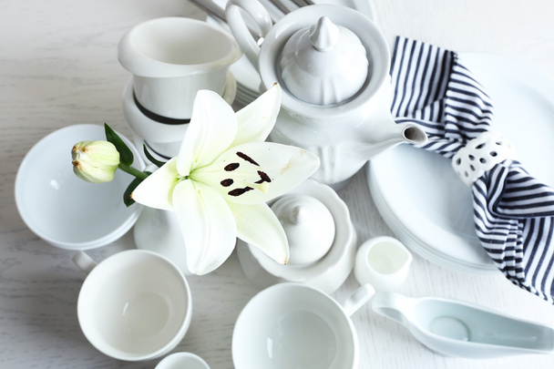 Set of white ceramics dishes on wooden table, closeup - Fotó, kép