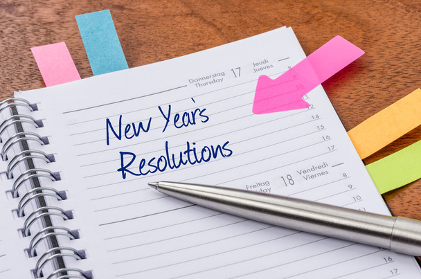 Daily planner with the entry New Years Resolutions - Photo, Image