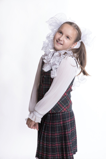 Schoolgirl with white bows dreams - Фото, зображення