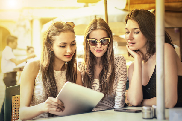 Three girls ordering from a menu - Photo, Image