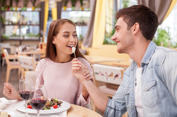 Cheerful boyfriend and girlfriend are resting in cafe - Photo, Image