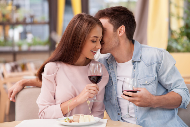 Pretty young loving couple is dating in restaurant - Foto, Imagem