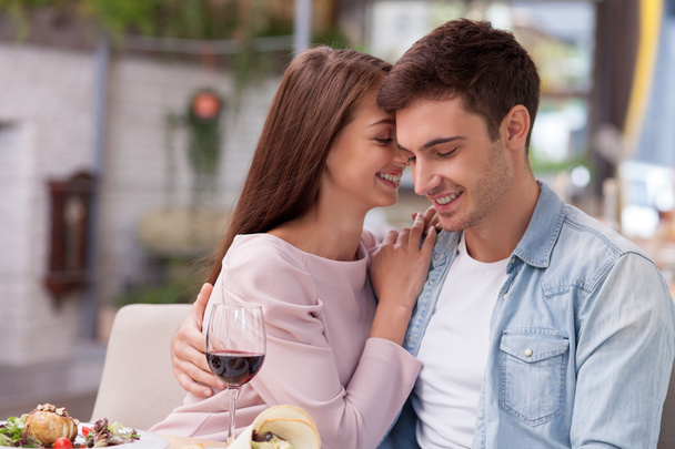 Cheerful man and woman are dating in restaurant - Φωτογραφία, εικόνα