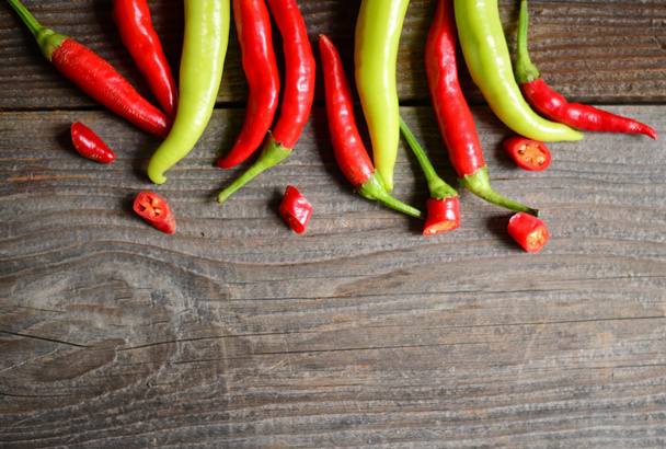 Chilly pepper ( yellow and red ) on the wooden background - Foto, Bild