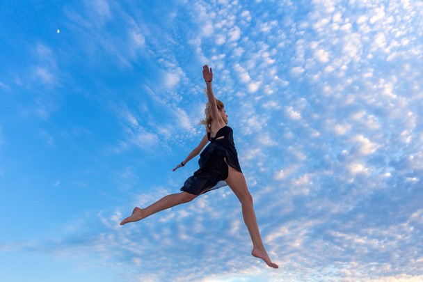 Young beautiful woman jumping - Фото, изображение