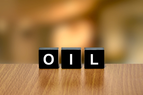 crude oil on black block - Foto, afbeelding