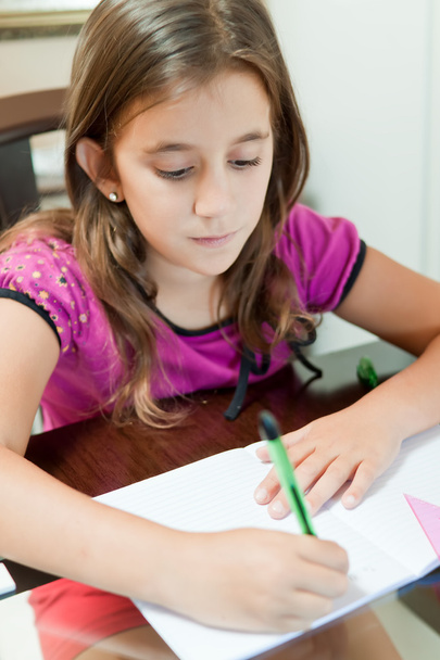 Small hispanic girl working on her homework - Foto, afbeelding