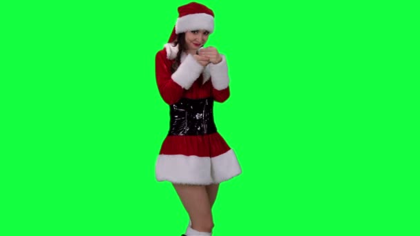 Sexy Santa's helper demonstrates an object chroma key (green screen) - Footage, Video