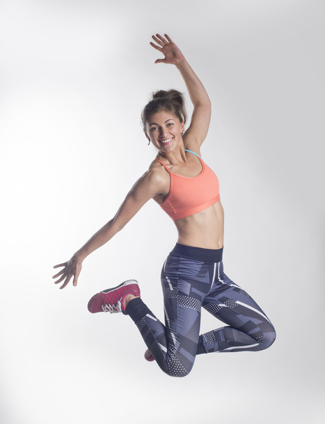 Sport girl jumping and smiling - Fotó, kép