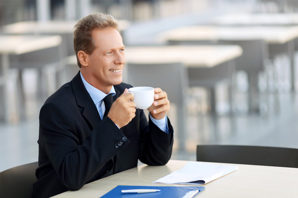 Handsome businessman sitting at the table - Photo, image