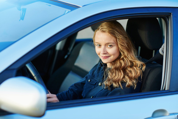 Young confident woman driving a car - Фото, изображение
