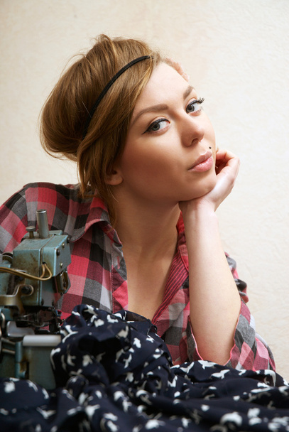 Woman seamstress posing near sewing machine - Φωτογραφία, εικόνα