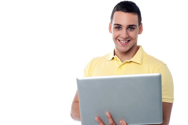 Teenager boy holding his laptop - Foto, Imagen