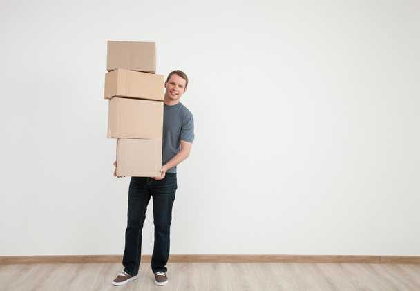 Man carrying many boxes - Foto, imagen
