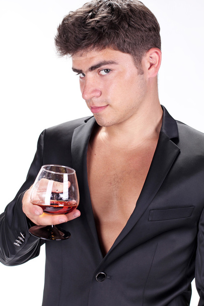 Man with glass of cognac on white background - Фото, зображення
