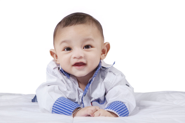 Attractive male infant laughing on bed - Foto, immagini