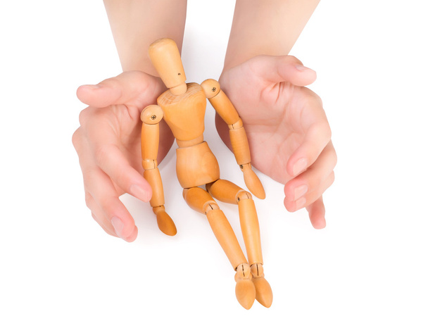 female hands covering wooden man - Photo, Image