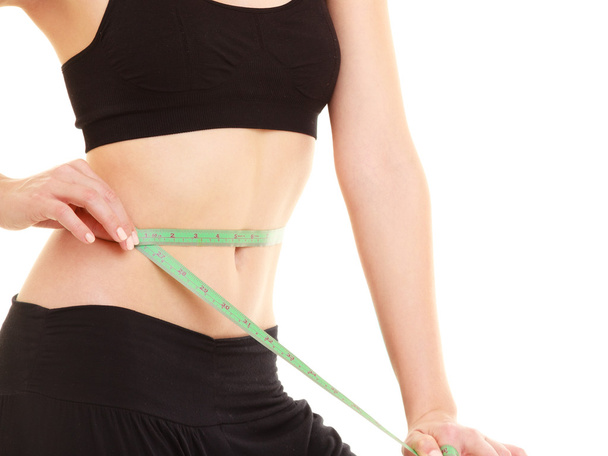 diet. slim fit girl with measure tape measuring waist - Foto, imagen